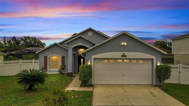 view of front of property with a yard and a garage