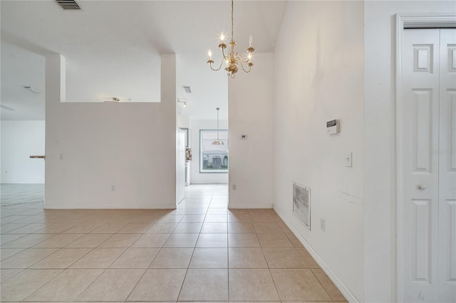 interior space with light tile patterned flooring and a notable chandelier