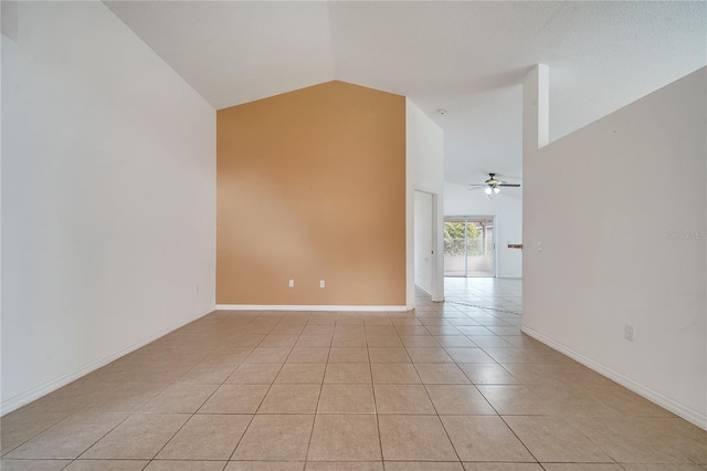 tiled empty room with ceiling fan and lofted ceiling