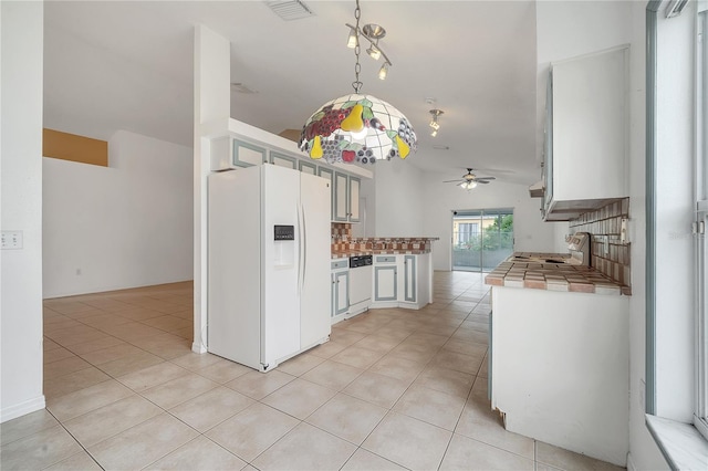 kitchen with white appliances, white cabinets, decorative backsplash, ceiling fan, and light tile patterned floors