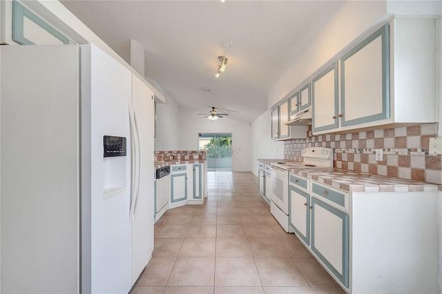 kitchen featuring lofted ceiling, white appliances, ceiling fan, tasteful backsplash, and light tile patterned flooring