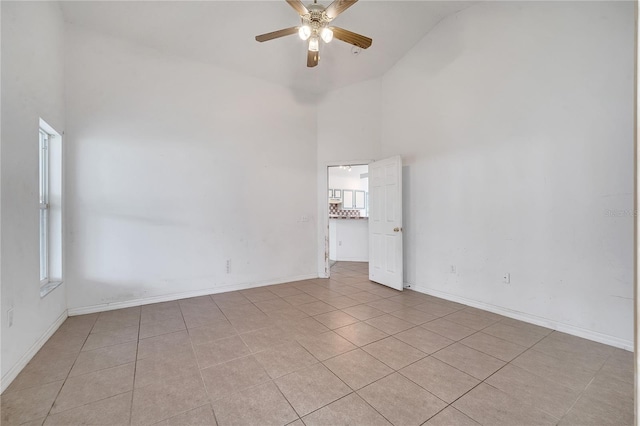 unfurnished room featuring ceiling fan, high vaulted ceiling, and light tile patterned flooring