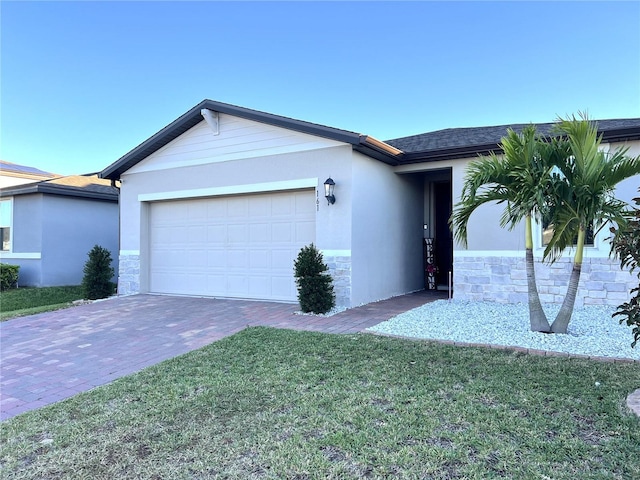 ranch-style home featuring a garage and a front lawn