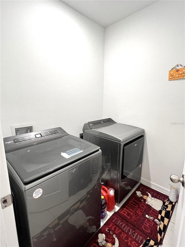 clothes washing area with separate washer and dryer