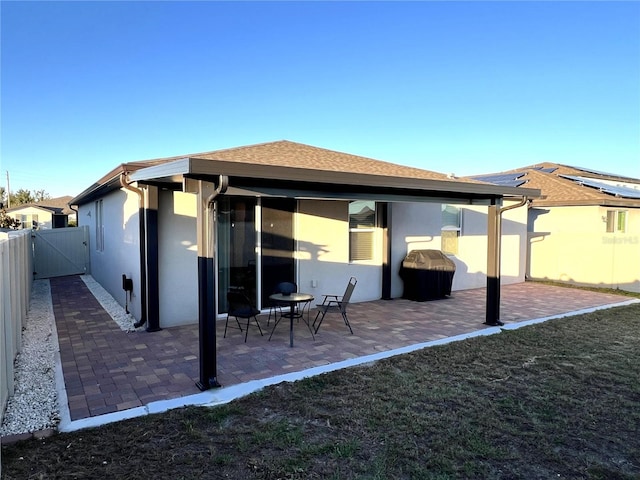 back of house with a yard and a patio