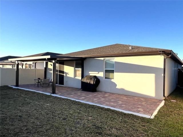 rear view of property with a patio area and a yard