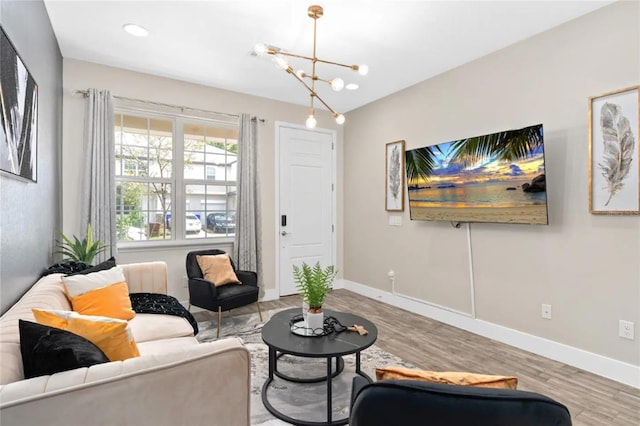 living room with a chandelier and light hardwood / wood-style floors