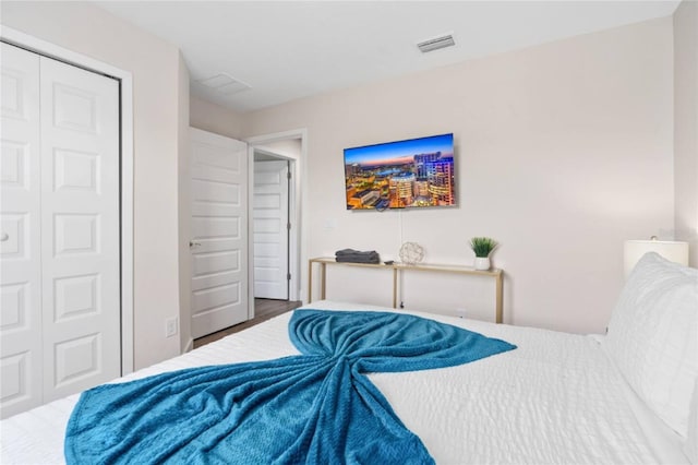 bedroom with wood-type flooring and a closet