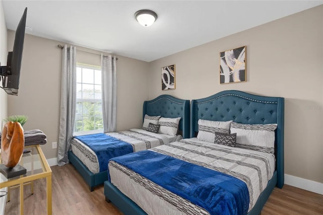 bedroom with hardwood / wood-style floors