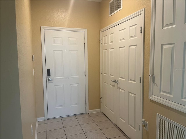 doorway featuring light tile patterned floors