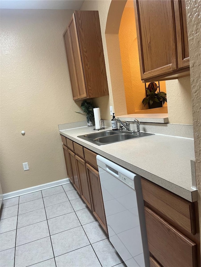 kitchen with dishwasher, light tile patterned flooring, and sink