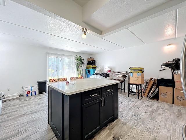 kitchen featuring a textured ceiling and light wood-type flooring