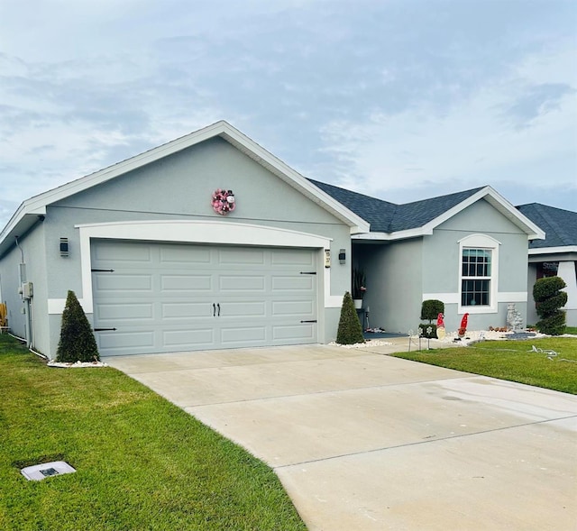 ranch-style home featuring a garage and a front lawn