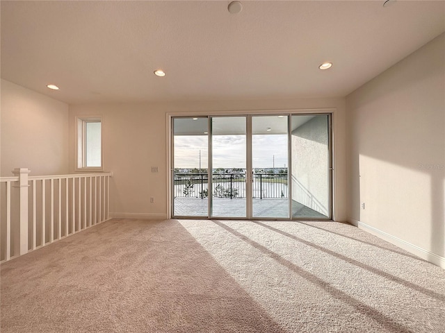 empty room featuring carpet and a water view