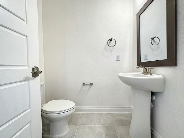 bathroom featuring tile patterned flooring and toilet