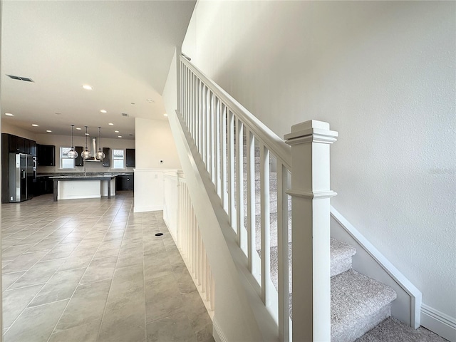 staircase featuring tile patterned flooring