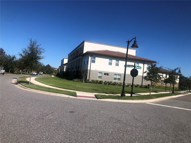 view of side of property with a yard