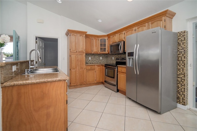 kitchen featuring sink, stainless steel appliances, tasteful backsplash, lofted ceiling, and light tile patterned flooring