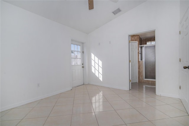 tiled spare room featuring ceiling fan and high vaulted ceiling