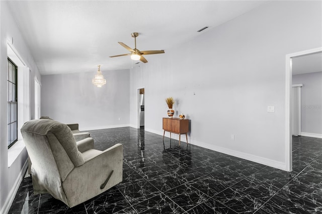 living room featuring ceiling fan and vaulted ceiling