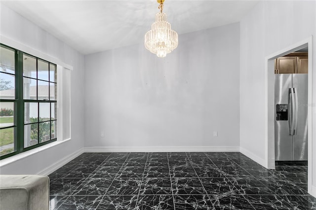 unfurnished room with a notable chandelier