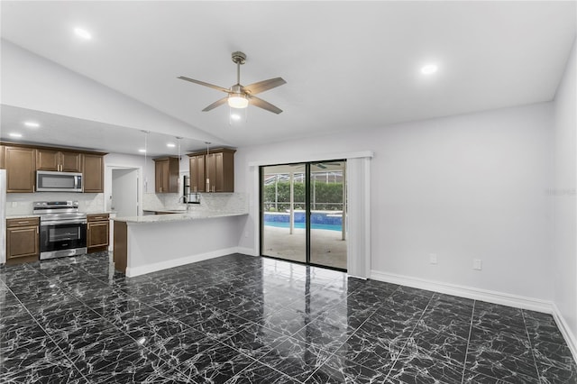 kitchen featuring lofted ceiling, ceiling fan, appliances with stainless steel finishes, backsplash, and kitchen peninsula