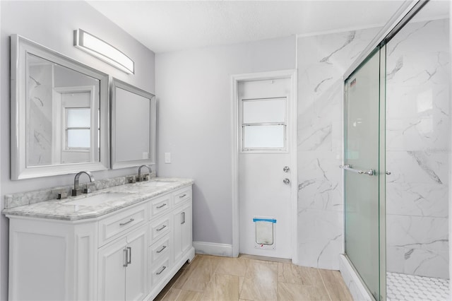 bathroom featuring vanity and a shower with shower door