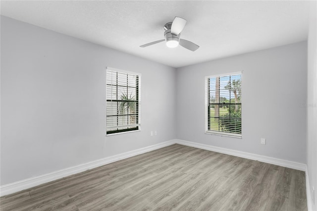 unfurnished room featuring ceiling fan, a textured ceiling, and light wood-type flooring