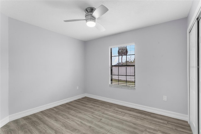 empty room with ceiling fan and light wood-type flooring