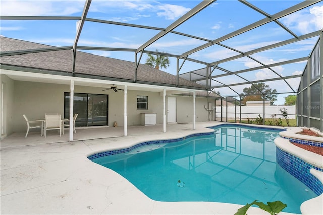 view of swimming pool featuring a lanai, ceiling fan, and a patio area