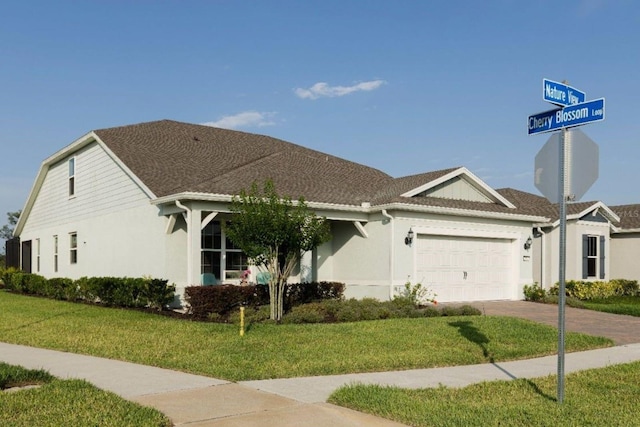 single story home featuring a garage and a front yard