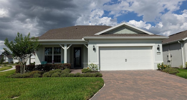 view of front of home with a front yard and a garage