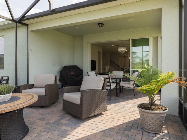 view of patio / terrace featuring a lanai and a grill