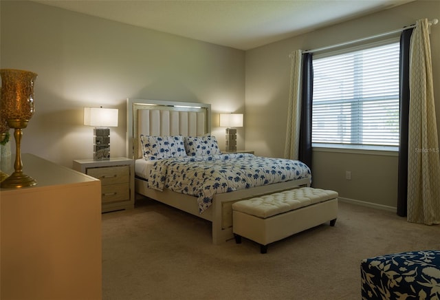 bedroom featuring light colored carpet