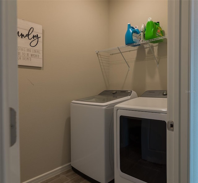 laundry area featuring dark hardwood / wood-style flooring and separate washer and dryer