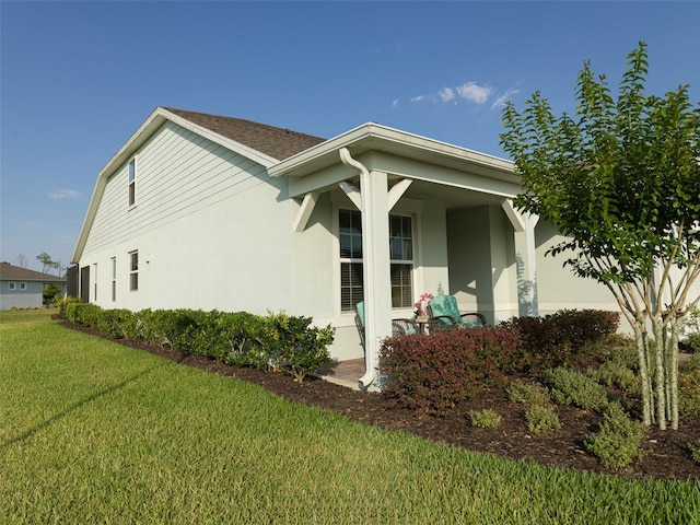 view of side of home featuring a yard