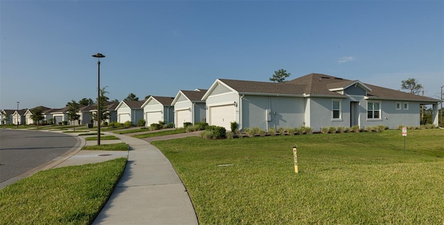 view of side of property with a yard and a garage