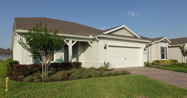 view of front of house with a garage and a front yard