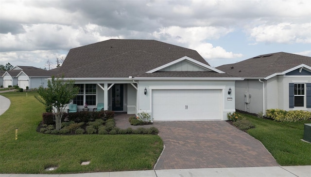 view of front facade with a garage and a front lawn