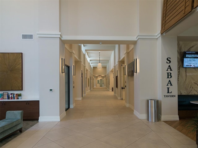 hall featuring light tile patterned floors