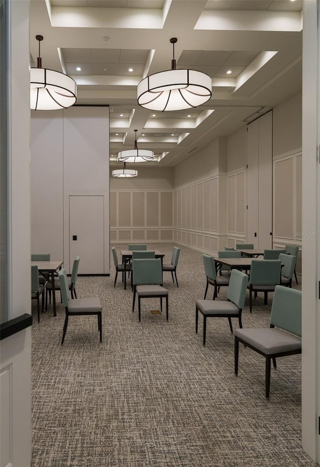 playroom with carpet, a raised ceiling, and coffered ceiling