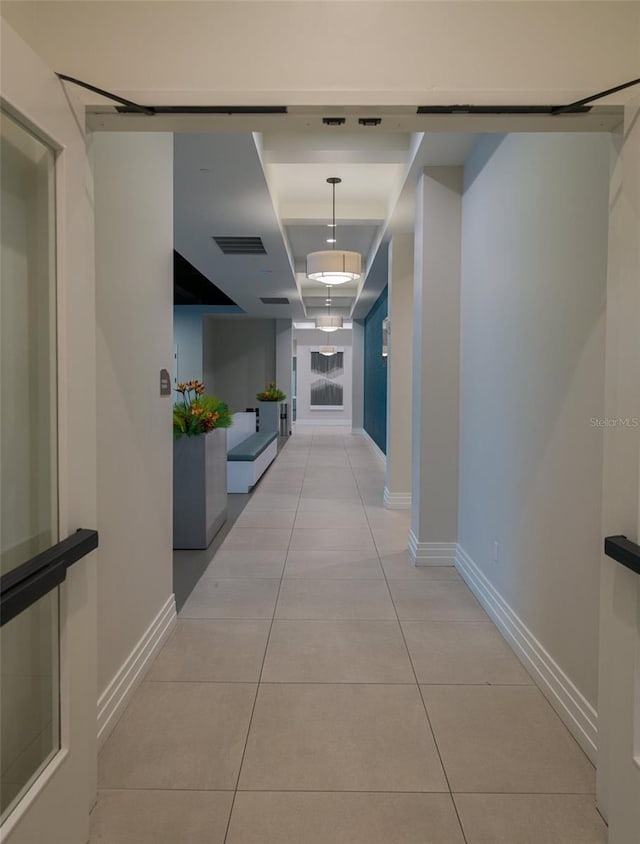 hall featuring light tile patterned flooring