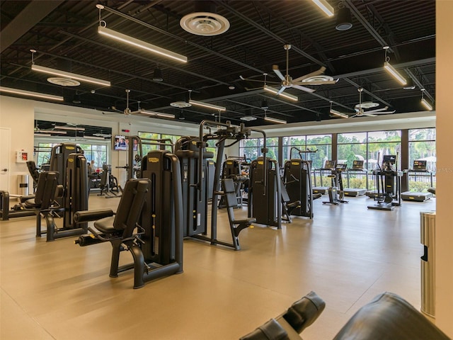 gym with ceiling fan and a wealth of natural light