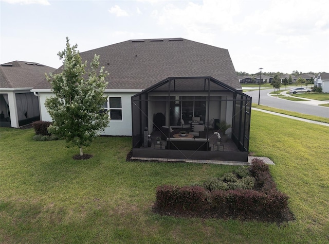 back of property featuring a lawn and a lanai