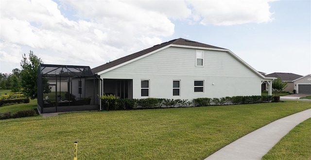 view of side of property featuring a lanai and a lawn