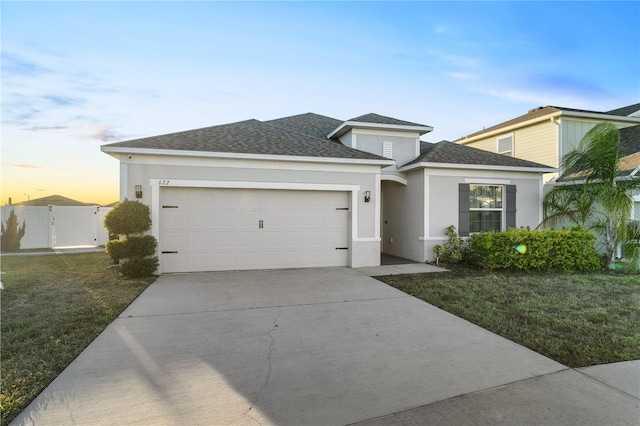 view of front of house with a garage and a lawn