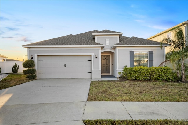 view of front of home with a lawn and a garage