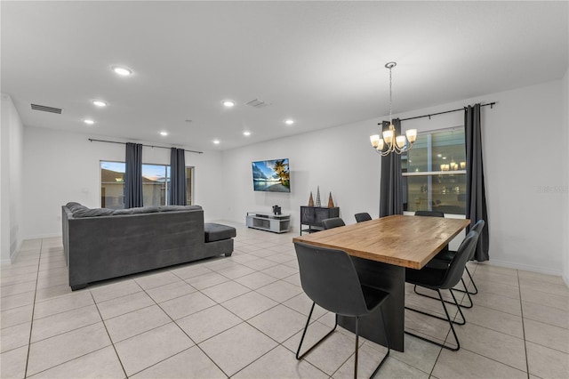 tiled dining space featuring an inviting chandelier