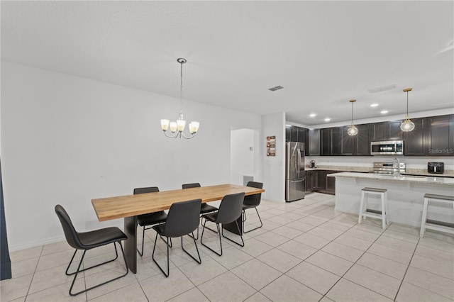 dining space with light tile patterned flooring and a chandelier