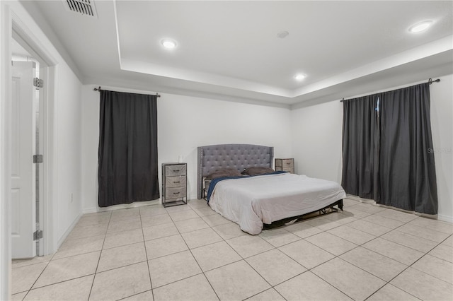 tiled bedroom featuring a raised ceiling